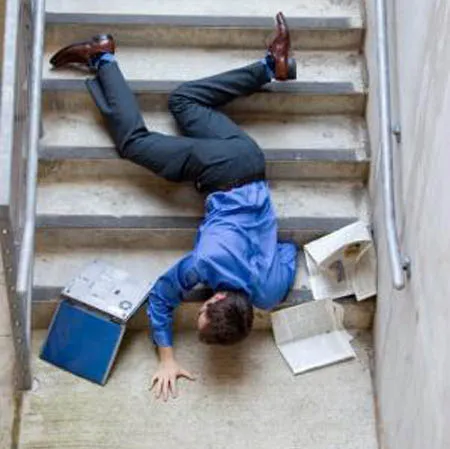 Business man falling down set of stairs
